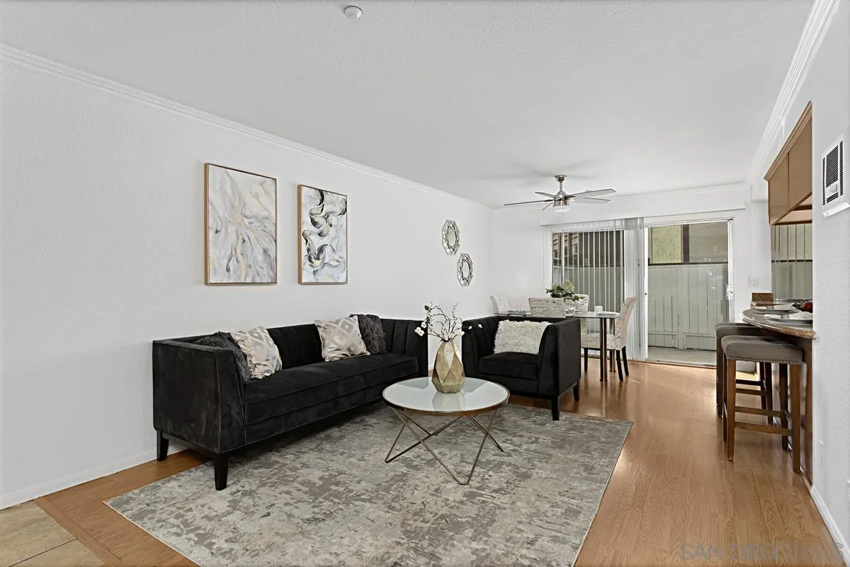 615 Fredricks Avenue, Unit 159 Oceanside, CA 92058 - Photo 6 of 26 a living room with furniture and a dining table with wooden floor
