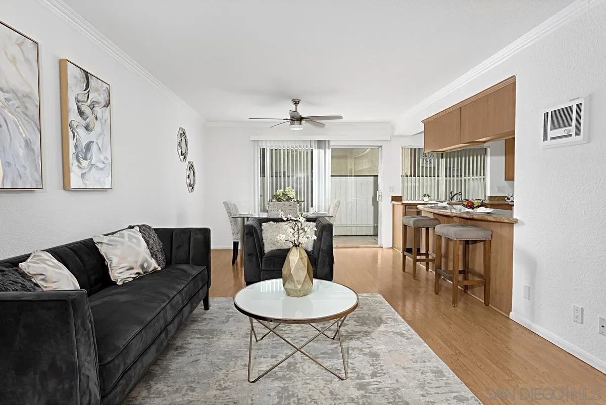 615 Fredricks Avenue, Unit 159 Oceanside, CA 92058 - Photo 8 of 26 a living room with furniture a dining table and a chandelier