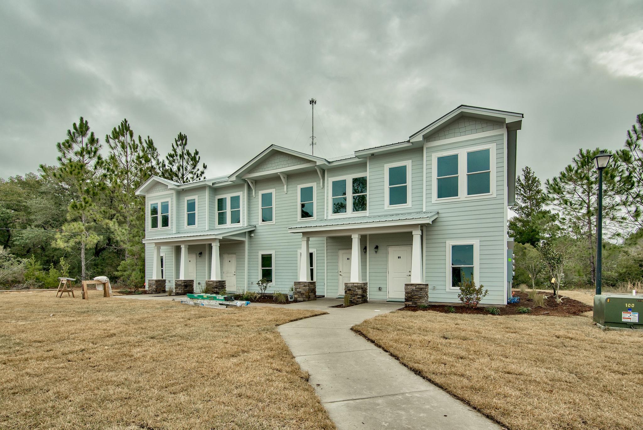 58 South Sand Palm Road, Unit LOT 40 Freeport, FL 32439 - Photo 30 of 34 a front view of a house with a yard