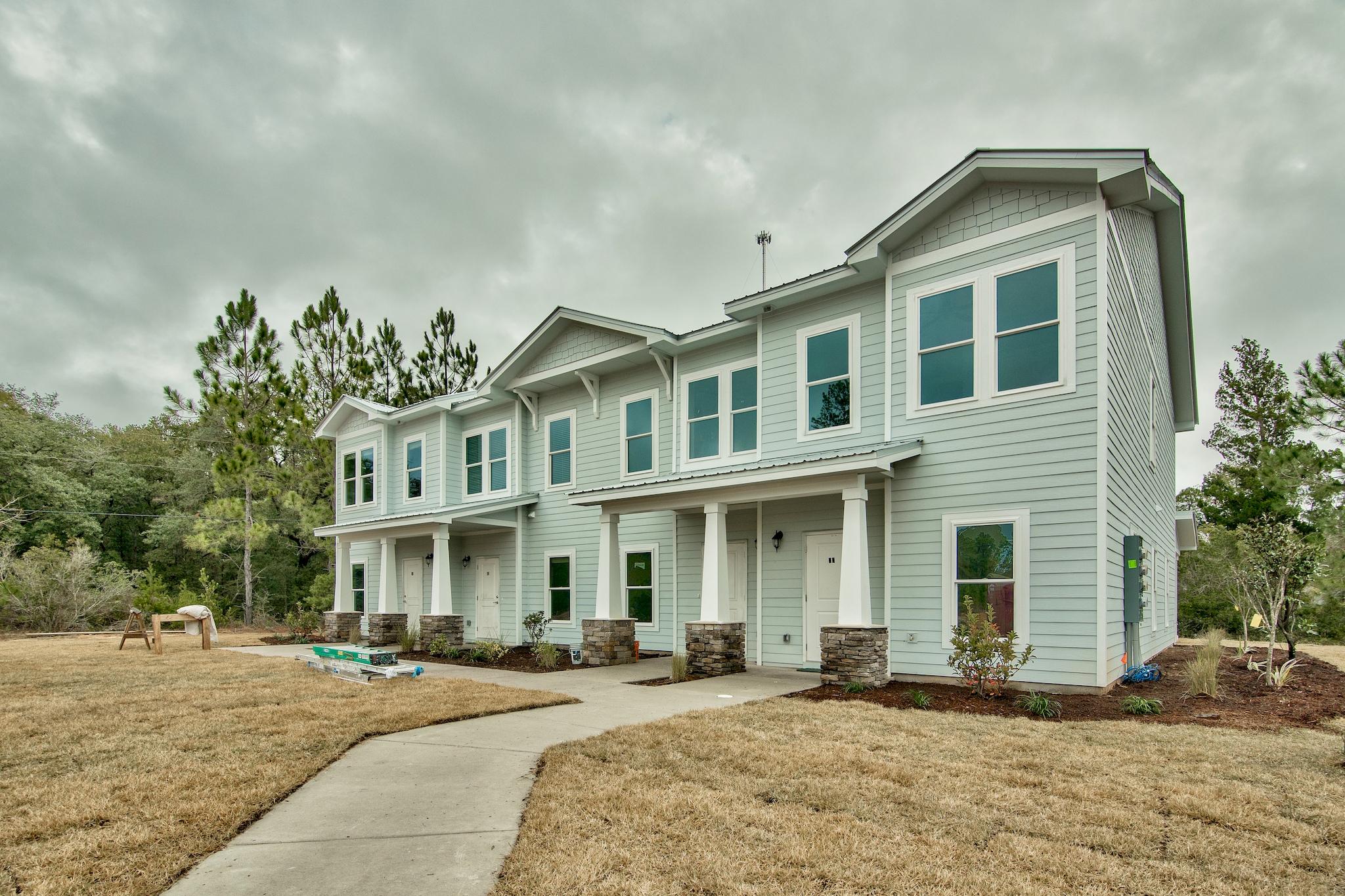 58 South Sand Palm Road, Unit LOT 40 Freeport, FL 32439 - Photo 32 of 34 a front view of a building and car parked