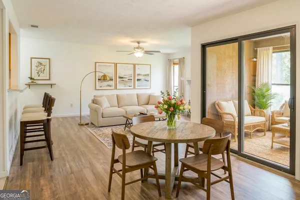 a view of a dining room with furniture and wooden floor