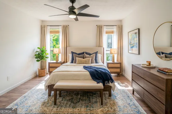 a bedroom with a bed and wooden floor