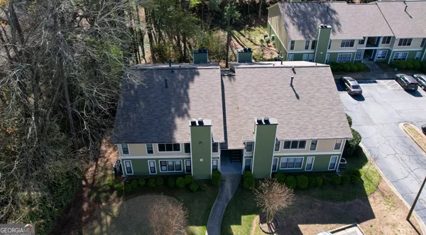 an aerial view of multiple houses with a yard
