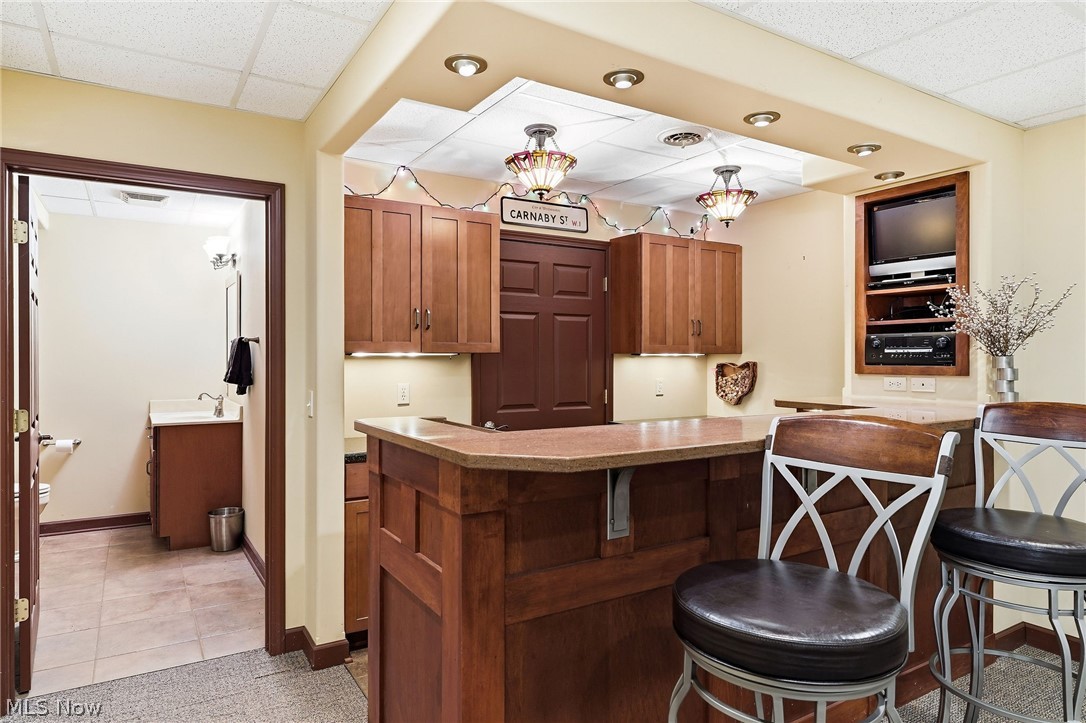 3199 Blake Road Wadsworth, OH 44281 - Photo 28 of 39 Full-service wet bar featuring wood cabinetry, recessed lighting, and a built-in media niche