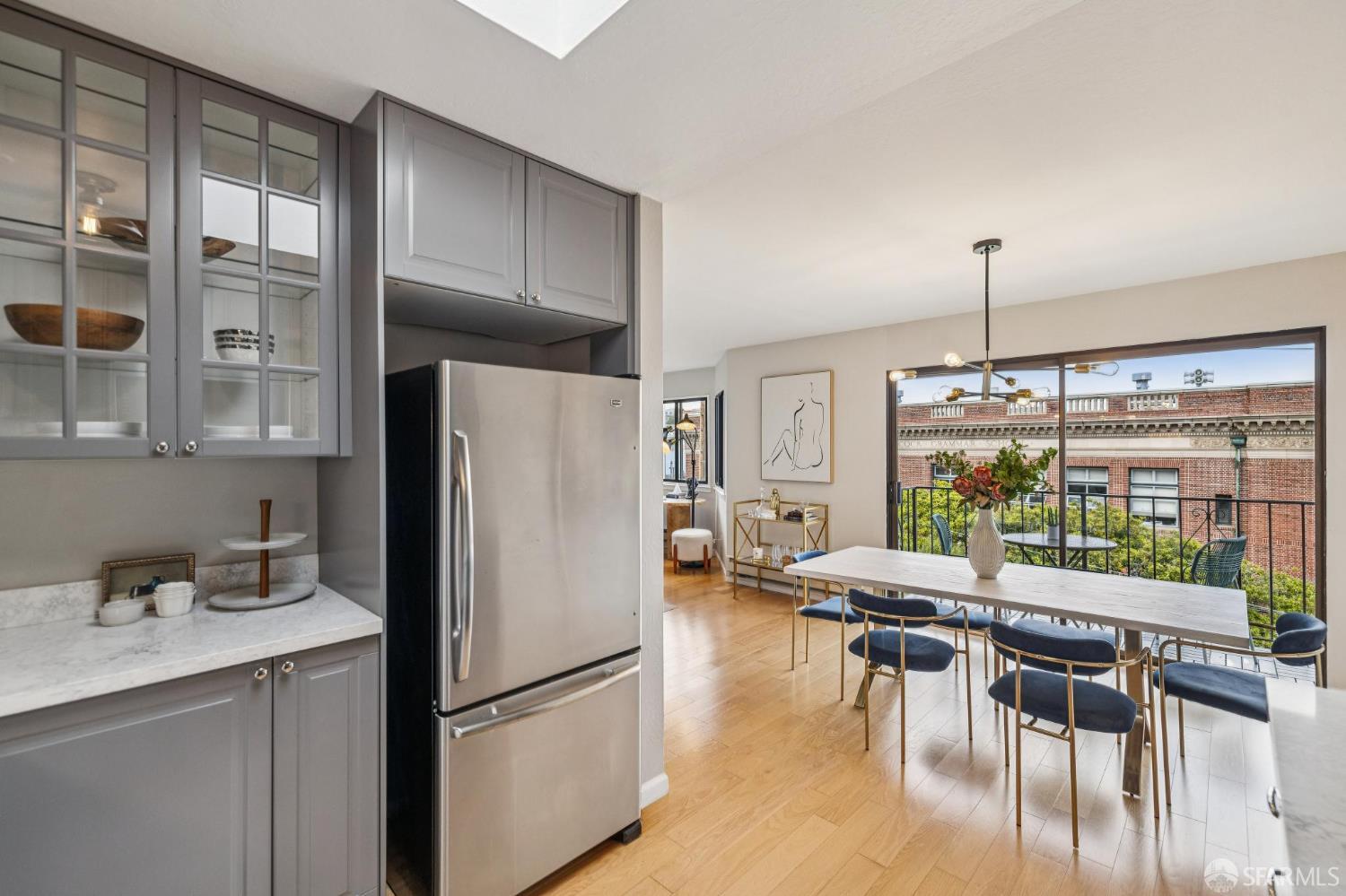 935 Filbert Street, Unit 3 San Francisco, CA 94133 - Photo 28 of 44 a kitchen with stainless steel appliances granite countertop a table chairs and a refrigerator