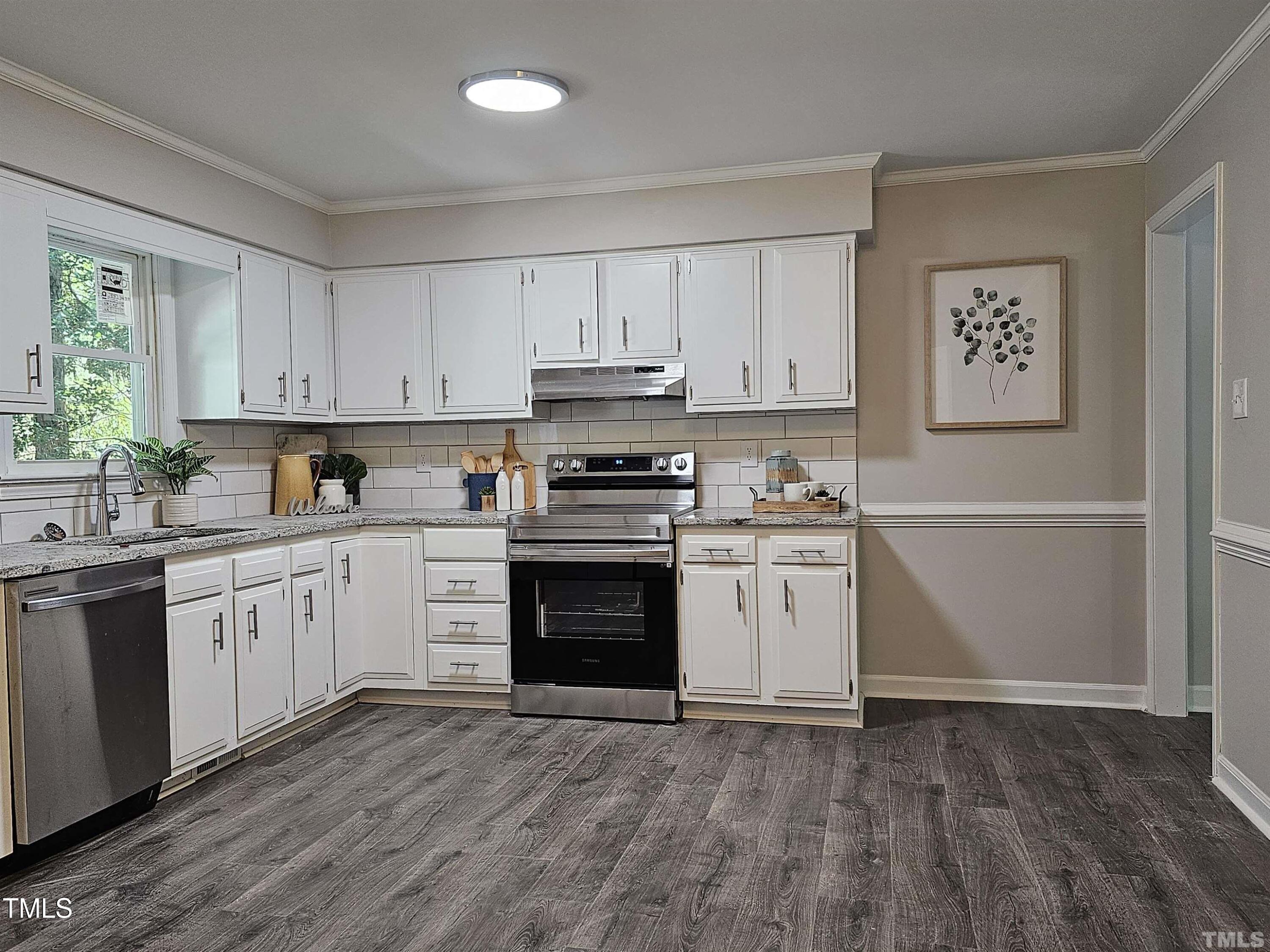 5906 Applewood Lane Raleigh, NC 27609 - Photo 2 of 14 a kitchen with granite countertop white cabinets and white appliances