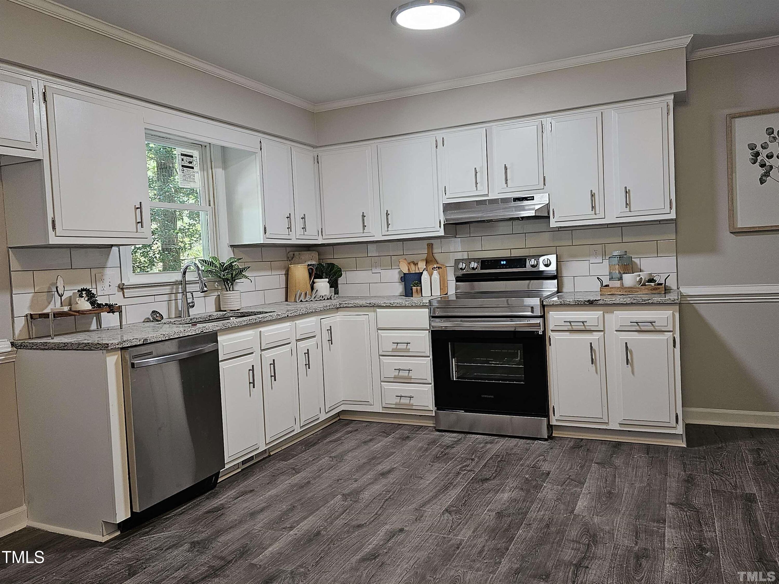 5906 Applewood Lane Raleigh, NC 27609 - Photo 3 of 14 a kitchen with a stove top oven sink and cabinets