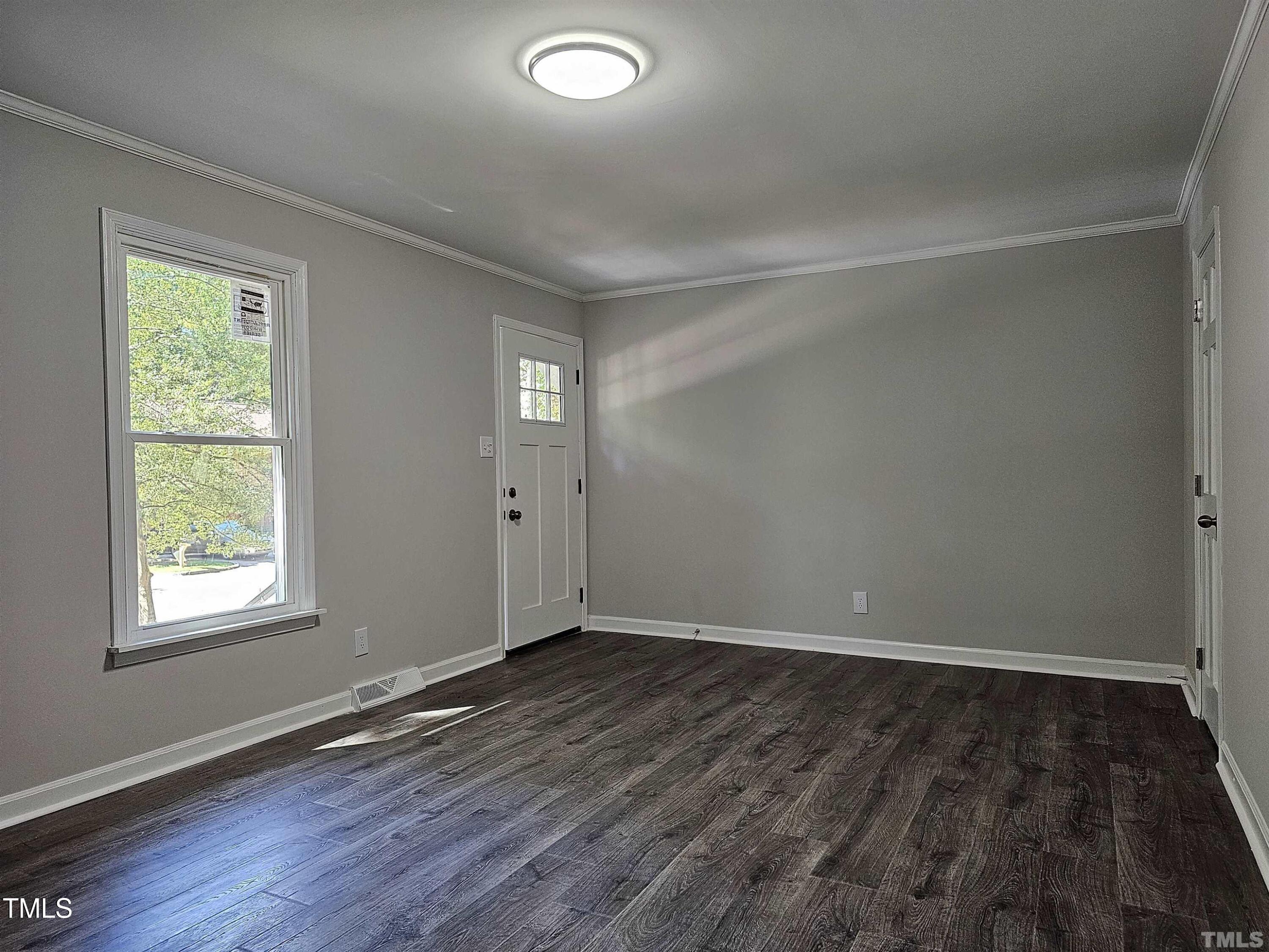 5906 Applewood Lane Raleigh, NC 27609 - Photo 5 of 14 an empty room with wooden floor and windows