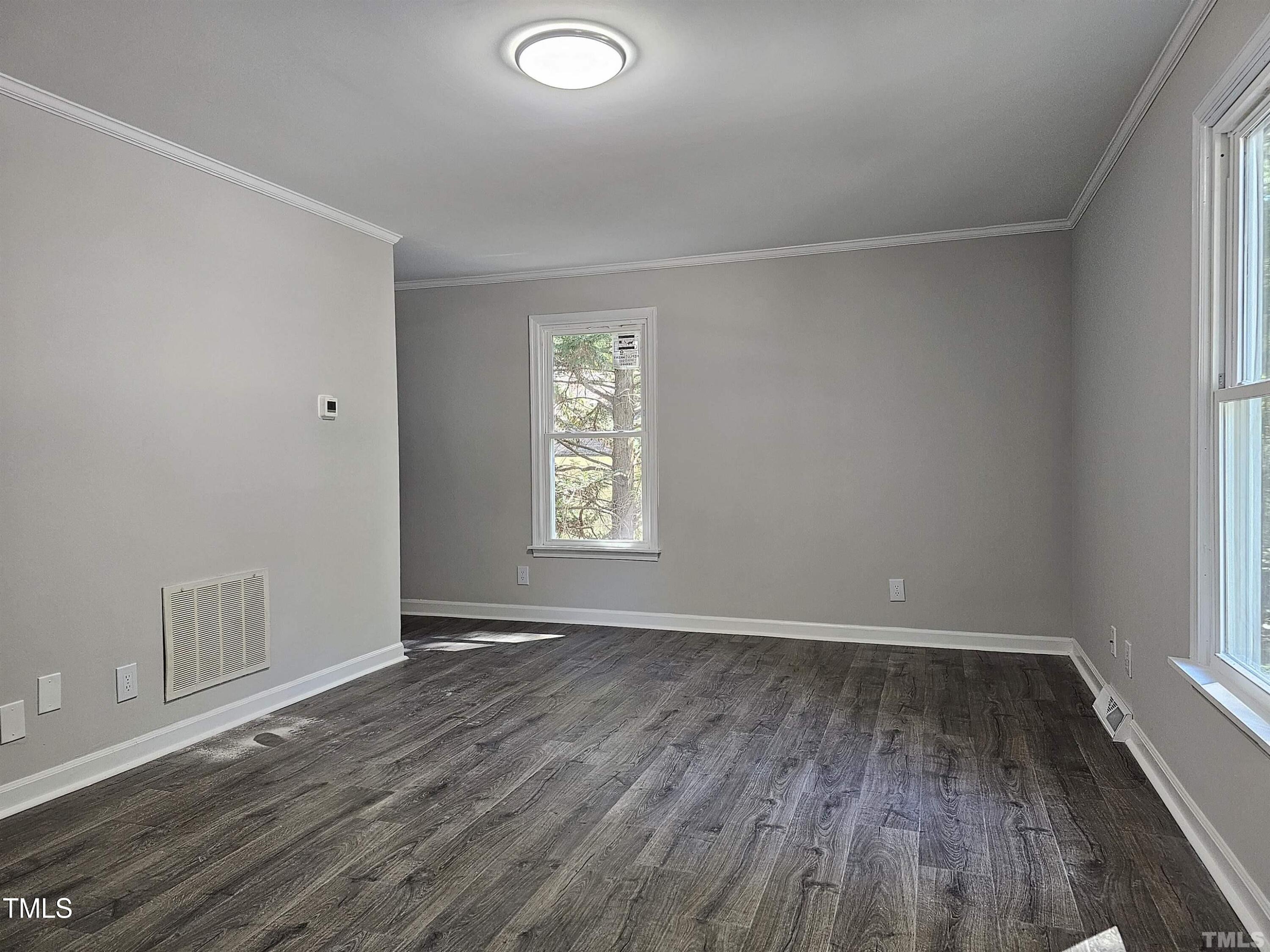 5906 Applewood Lane Raleigh, NC 27609 - Photo 6 of 14 an empty room with wooden floor and windows
