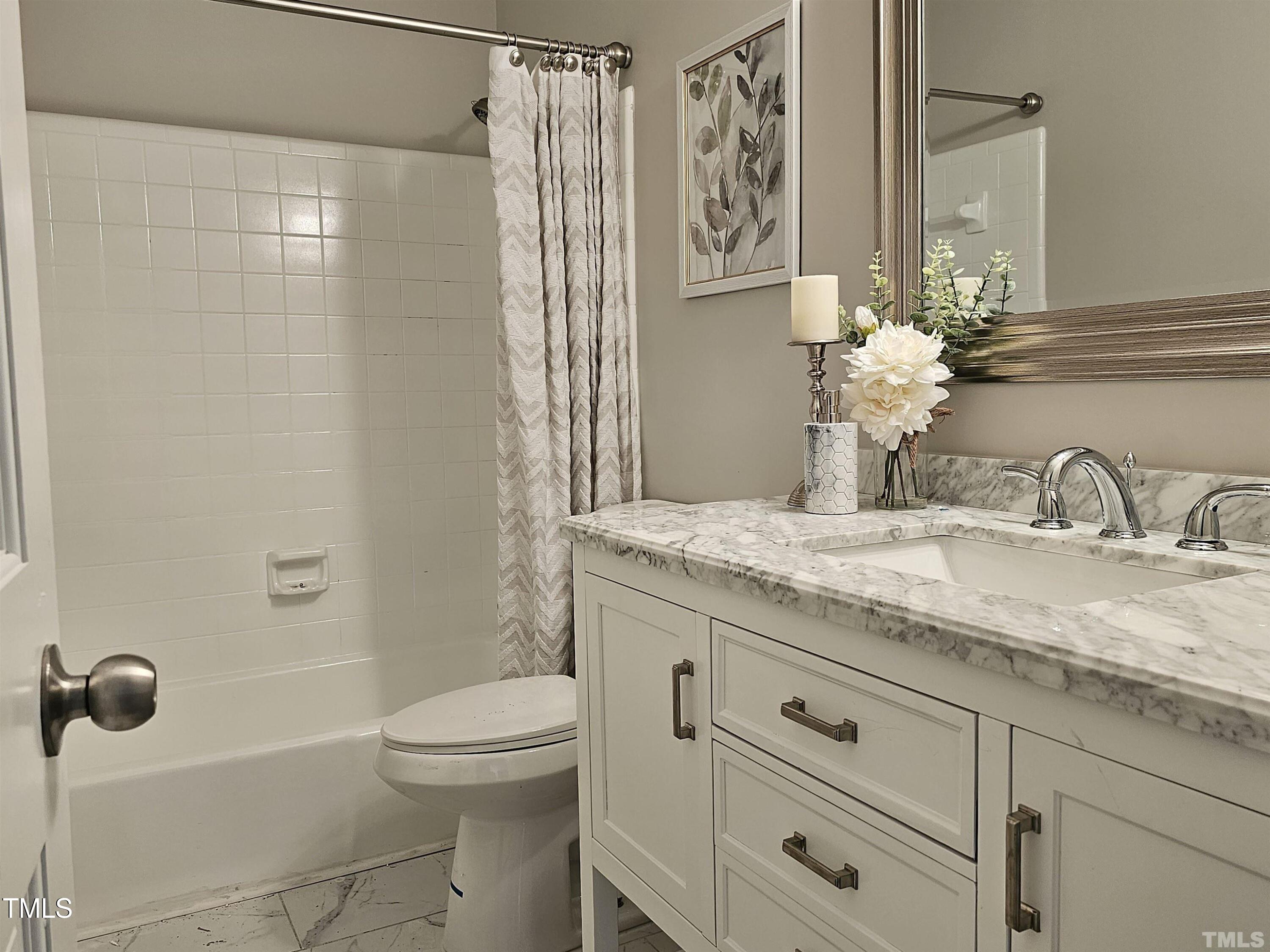 5906 Applewood Lane Raleigh, NC 27609 - Photo 9 of 14 a bathroom with a granite countertop sink a toilet and shower