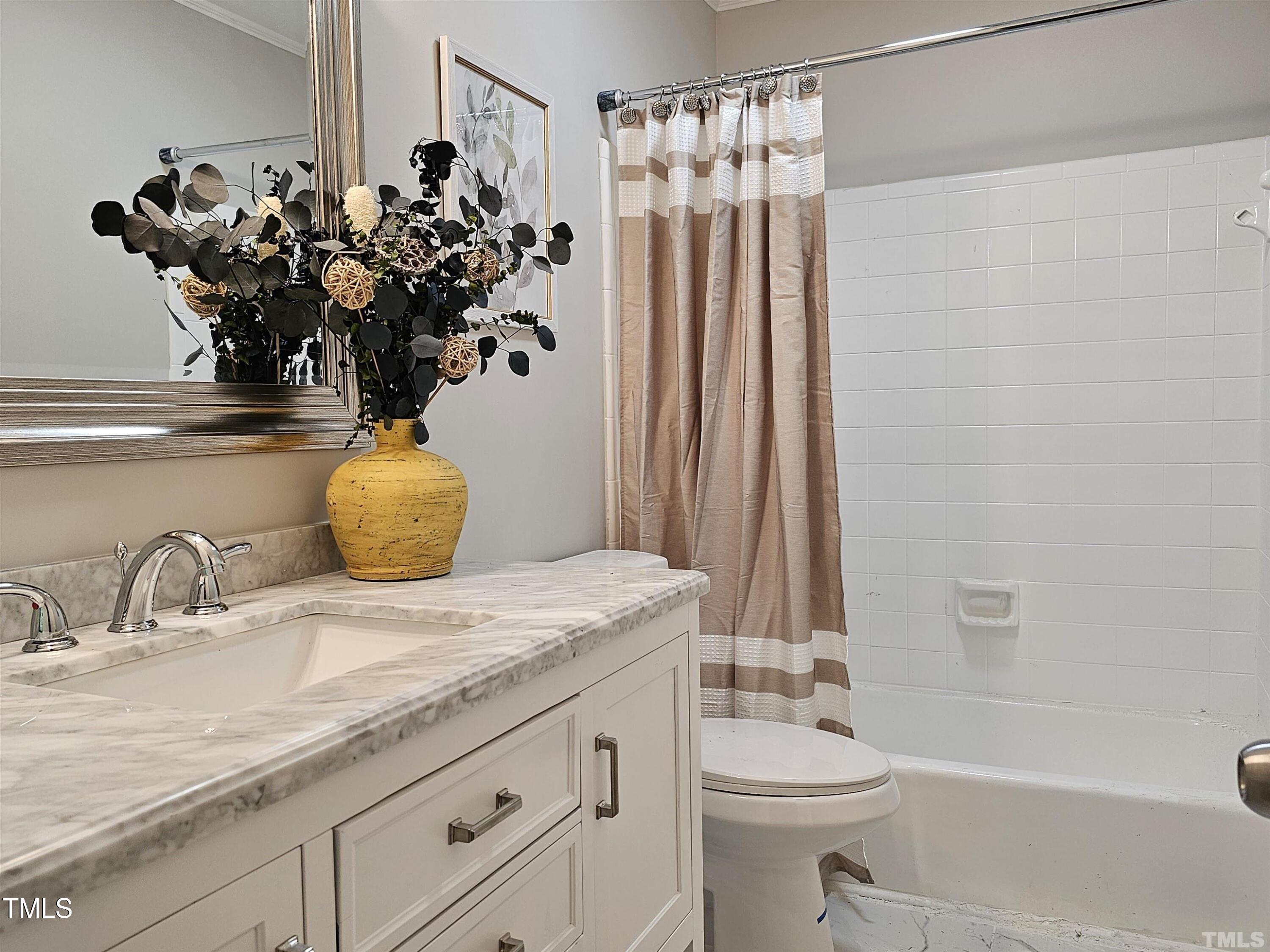 5906 Applewood Lane Raleigh, NC 27609 - Photo 10 of 14 a bathroom with a granite countertop sink a toilet and shower