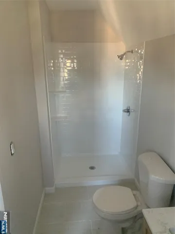 a bathroom with a toilet and a shower