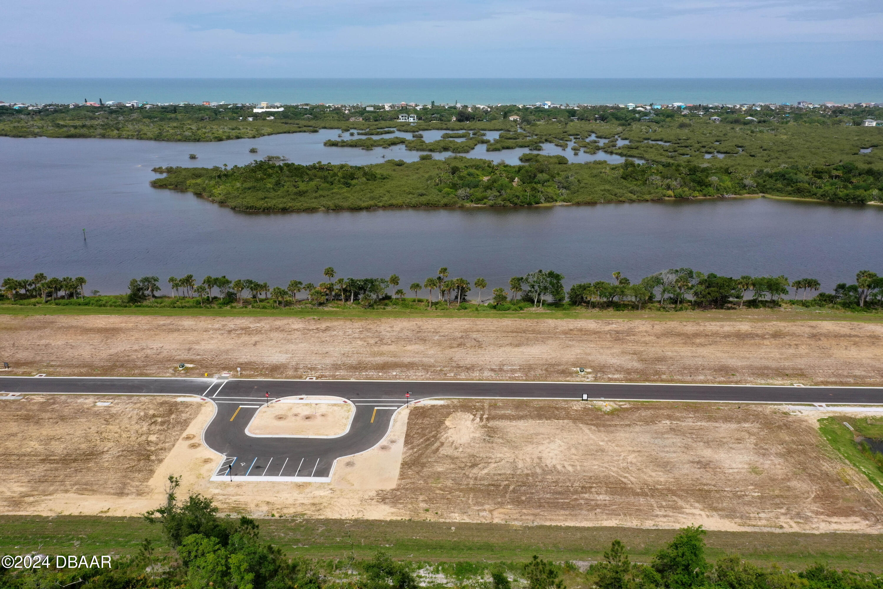 an aerial view of residential building ocean and trees