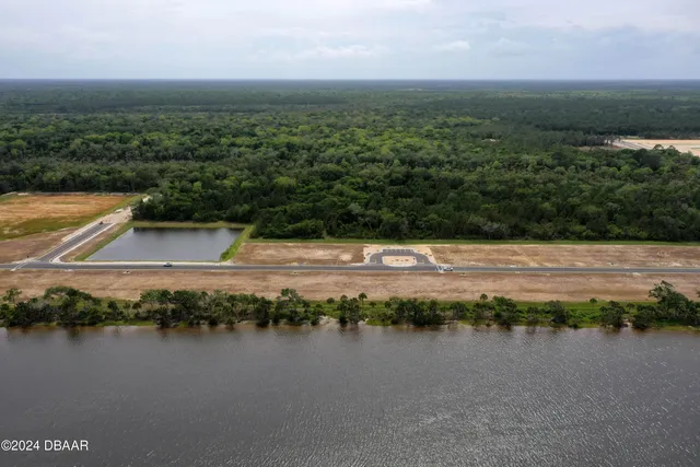 an aerial view of lake and mountain