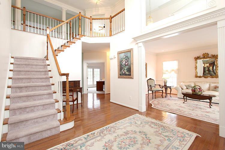 1296 Gatesmeadow Way Reston, VA 20194 - Photo 2 of 29 a view of an entryway and livingroom with furniture