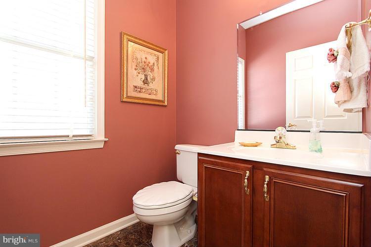 1296 Gatesmeadow Way Reston, VA 20194 - Photo 12 of 29 a bathroom with a granite countertop toilet sink and mirror