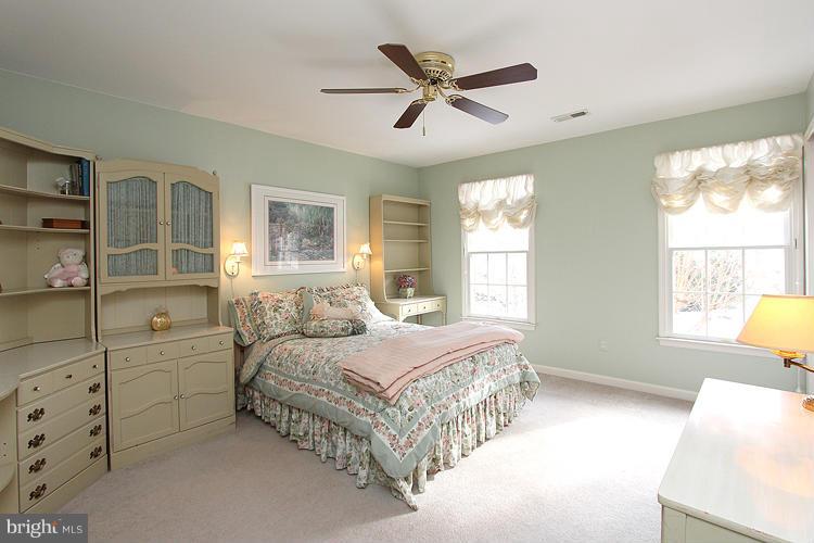 1296 Gatesmeadow Way Reston, VA 20194 - Photo 13 of 29 a spacious bedroom with a bed a window and walk in closet