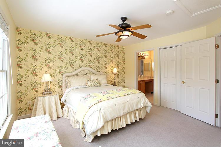 1296 Gatesmeadow Way Reston, VA 20194 - Photo 15 of 29 a bedroom with a bed and a chandelier