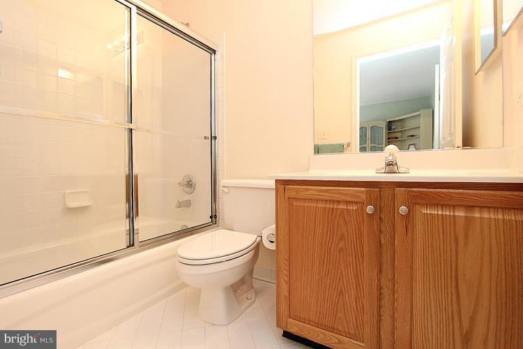 1296 Gatesmeadow Way Reston, VA 20194 - Photo 16 of 29 a bathroom with a granite countertop sink toilet and shower