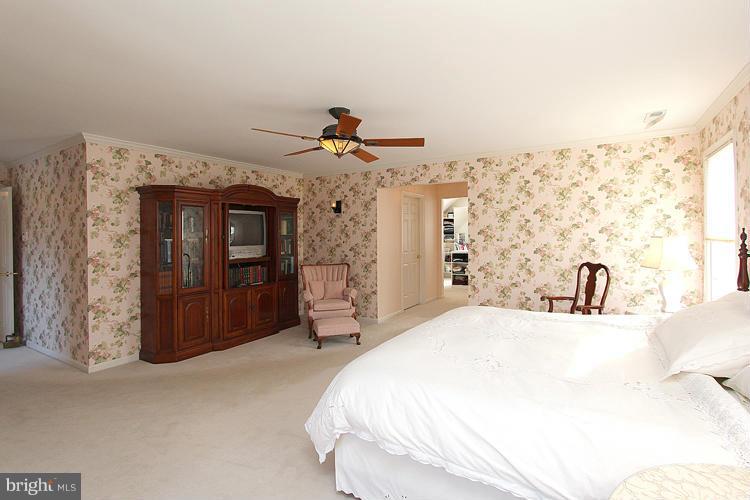 1296 Gatesmeadow Way Reston, VA 20194 - Photo 18 of 29 a spacious bedroom with a bed and a dresser