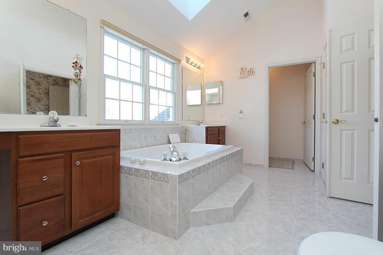 1296 Gatesmeadow Way Reston, VA 20194 - Photo 22 of 29 a bathroom with a sink double vanity and a mirror
