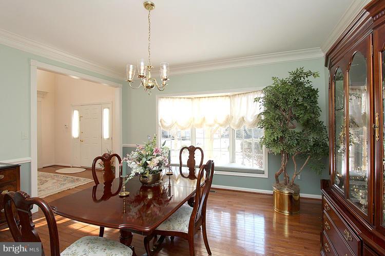 1296 Gatesmeadow Way Reston, VA 20194 - Photo 4 of 29 a view of a dining room with furniture window and wooden floor