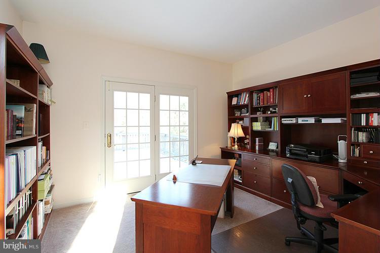 1296 Gatesmeadow Way Reston, VA 20194 - Photo 5 of 29 a living room with furniture a bookshelf and a flat screen tv