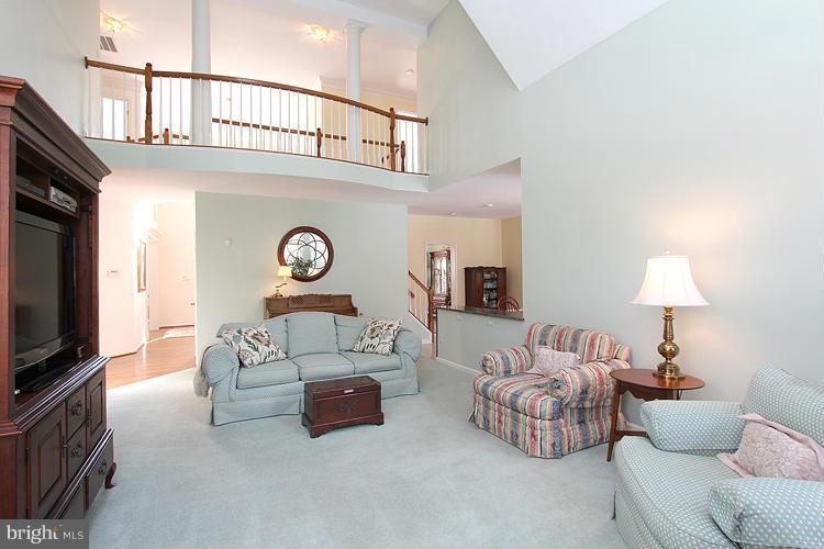 1296 Gatesmeadow Way Reston, VA 20194 - Photo 7 of 29 a living room with furniture a flat screen tv and a window