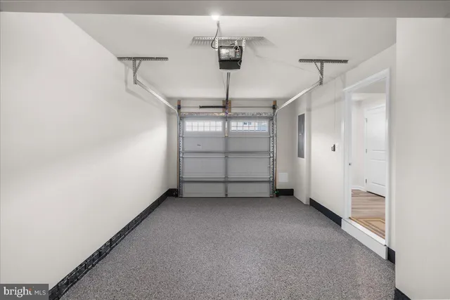 an empty room with windows and ceiling fan