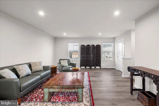 a living room with furniture and a rug