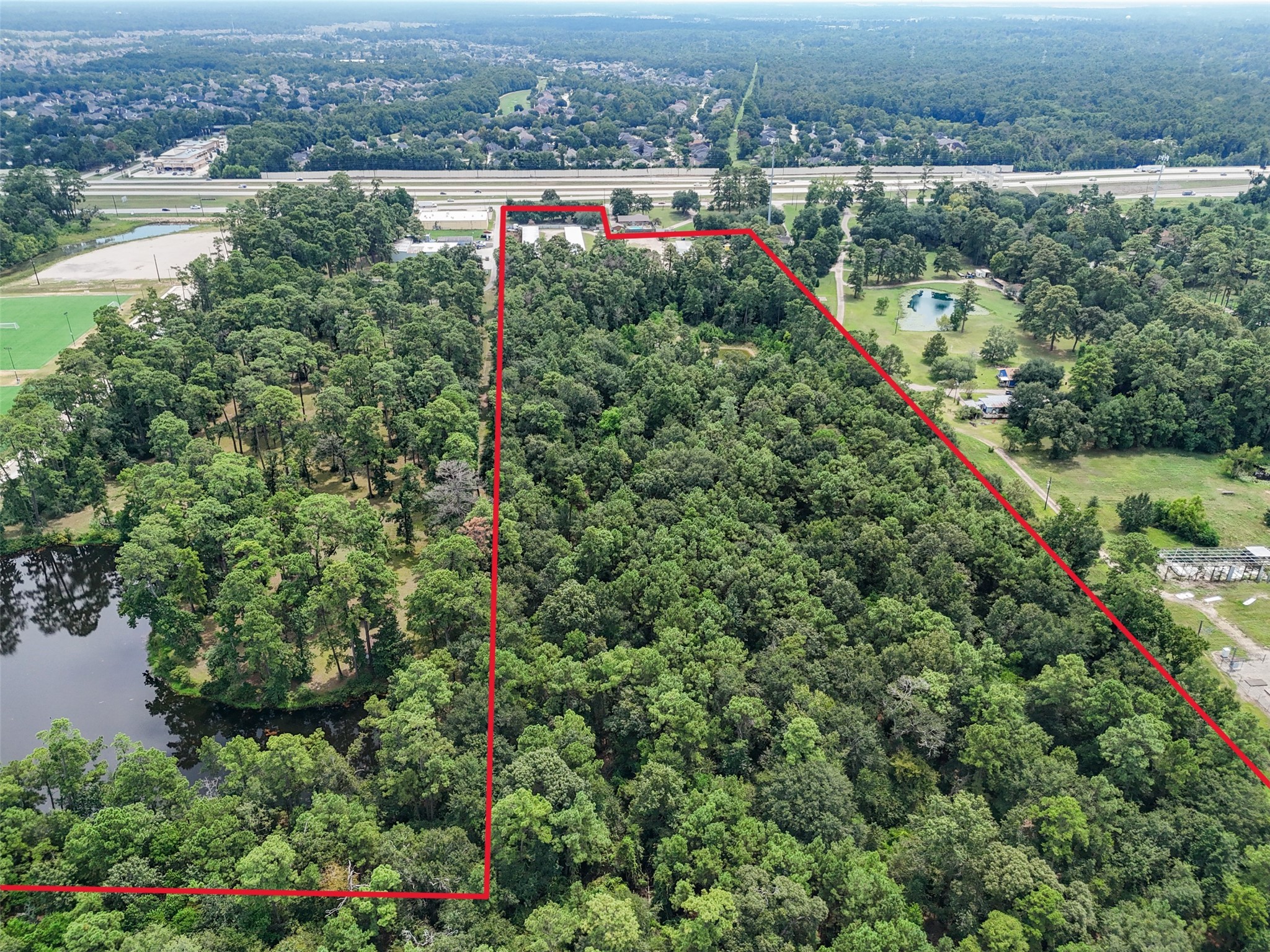 1803 Riley Fuzzel Road Spring, TX 77386 - Photo 5 of 6 an aerial view of a houses with a yard and lake