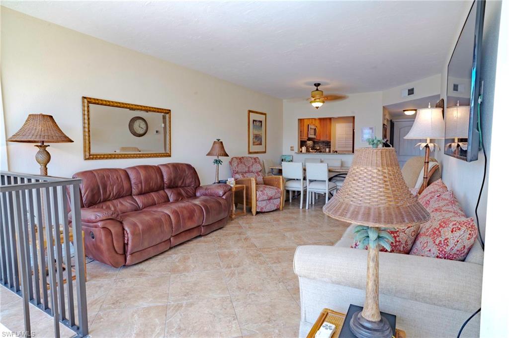 805 River Point Drive, Unit 103C Naples, FL 34102 - Photo 11 of 27 a living room with furniture and a window