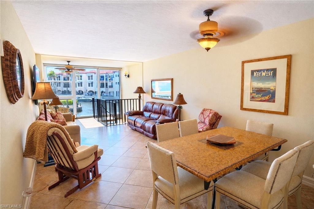 805 River Point Drive, Unit 103C Naples, FL 34102 - Photo 12 of 27 a living room with furniture and a flat screen tv