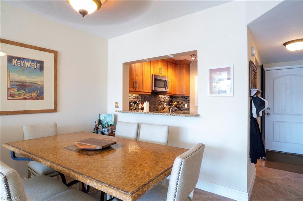 805 River Point Drive, Unit 103C Naples, FL 34102 - Photo 13 of 27 a view of a dining room with furniture and a table