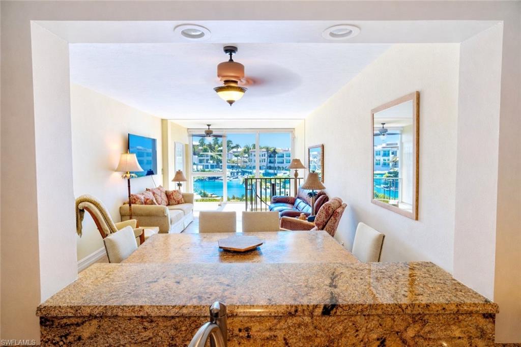 805 River Point Drive, Unit 103C Naples, FL 34102 - Photo 14 of 27 a view of a dining room with a table and chairs