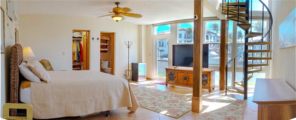 805 River Point Drive, Unit 103C Naples, FL 34102 - Photo 18 of 27 a bedroom with a bed dresser and a large mirror