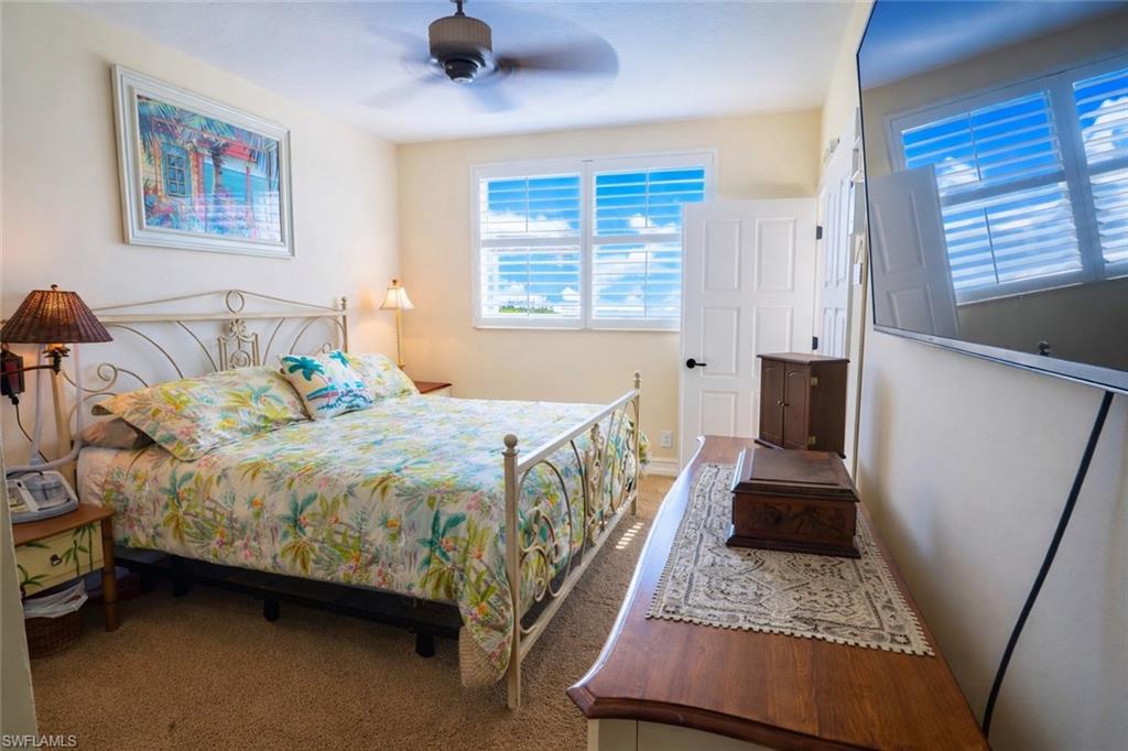 805 River Point Drive, Unit 103C Naples, FL 34102 - Photo 24 of 27 a bedroom with a bed couch and a window