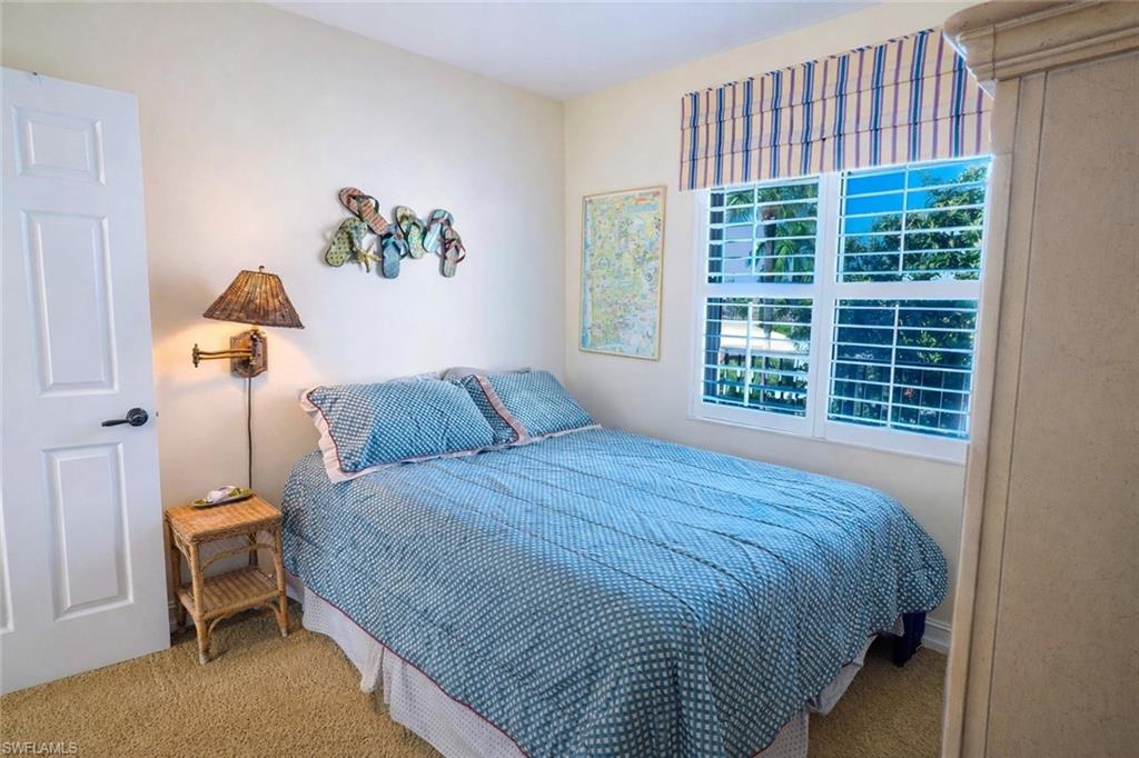 805 River Point Drive, Unit 103C Naples, FL 34102 - Photo 26 of 27 a bedroom with a bed and a window