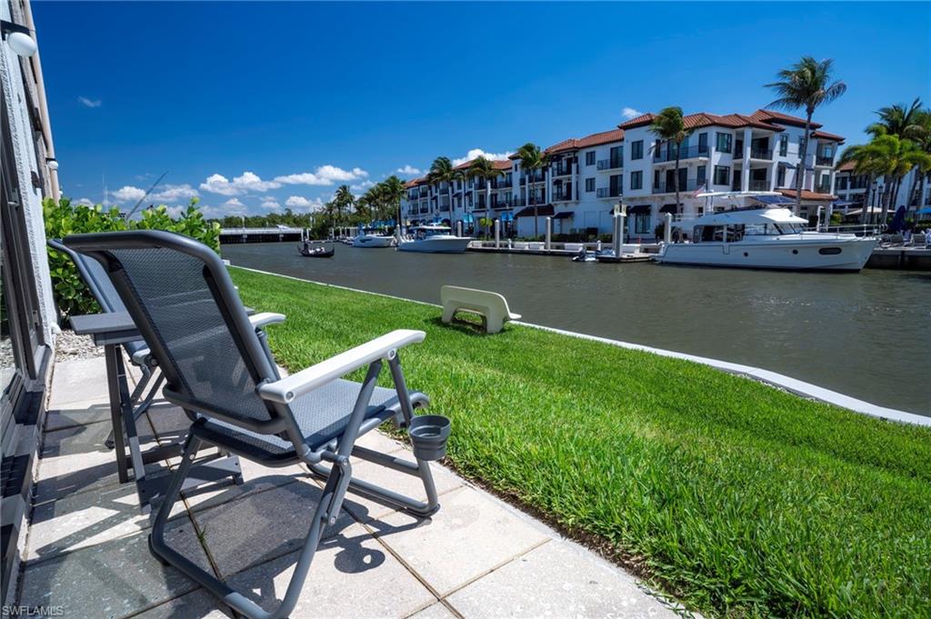 805 River Point Drive, Unit 103C Naples, FL 34102 - Photo 8 of 27 a view of a chairs and table on the terrace