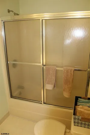 a bathroom with a glass shower door