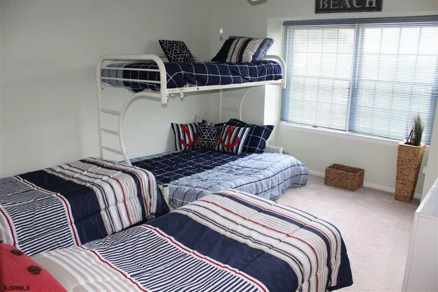 a bedroom with two beds and a window