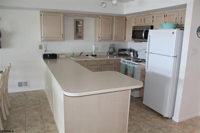 a white refrigerator freezer sitting inside of a kitchen