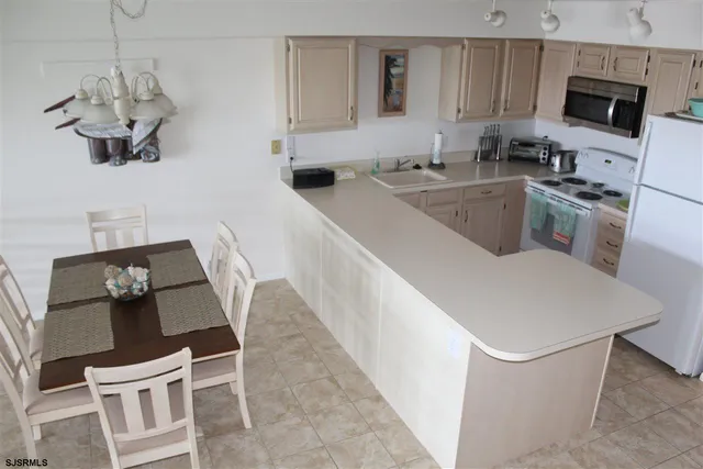 a kitchen with a sink appliances and cabinets