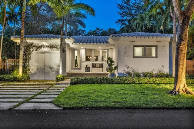 a front view of a house with a garden