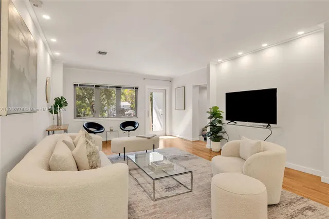 a kitchen with kitchen island a stove and a microwave