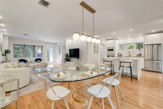 a view of a dining room with furniture wooden floor and a chandelier