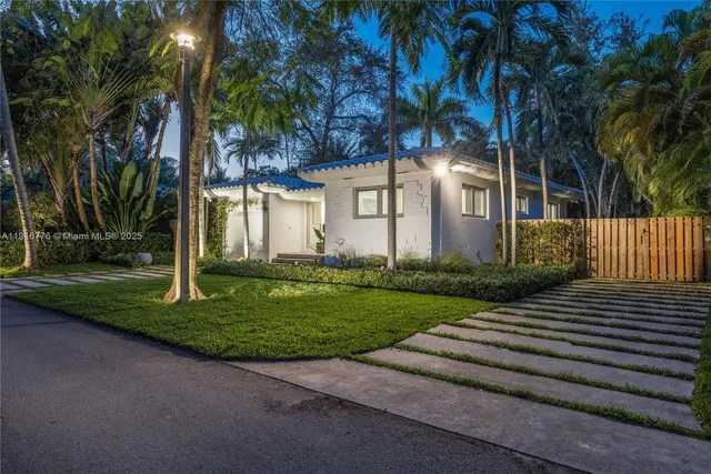 a view of a chairs setting in back yard of the house