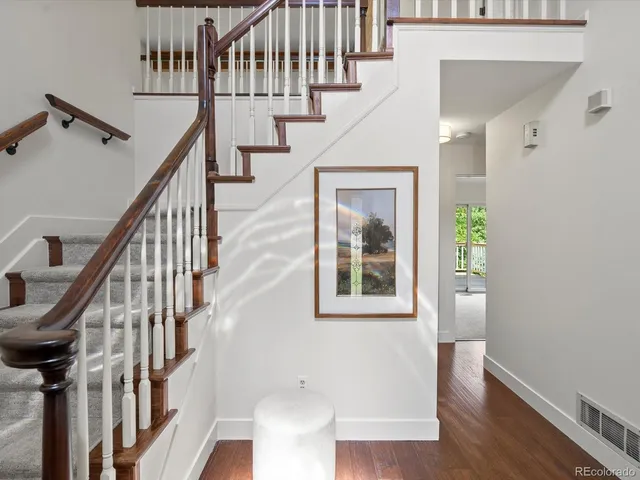 a view of staircase with lots of frames and wooden floor