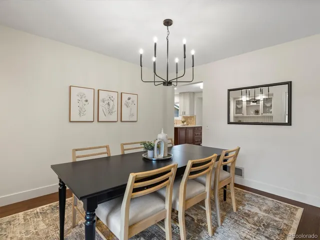 a view of a dining room with furniture a chandelier and wooden floor