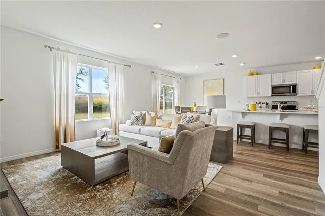 a living room with fireplace furniture and a wooden floor